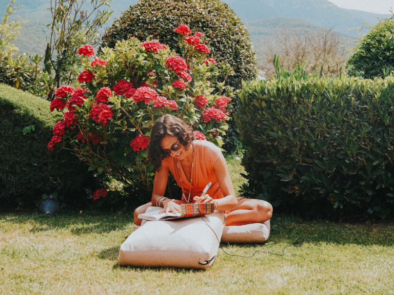 Woman writing in garden setting. | Mahanse